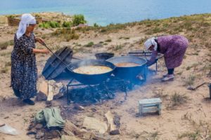 two women cooking at issyk kul kyrgyzstan